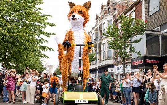 EDITORIAL USE ONLY Puppet Farrah the Fox parades the streets of Lowestoft to launch Historic England's Hi! Street Fest, created in partnership with Emergency Exit Arts. Picture date: Saturday June 17, 2023.