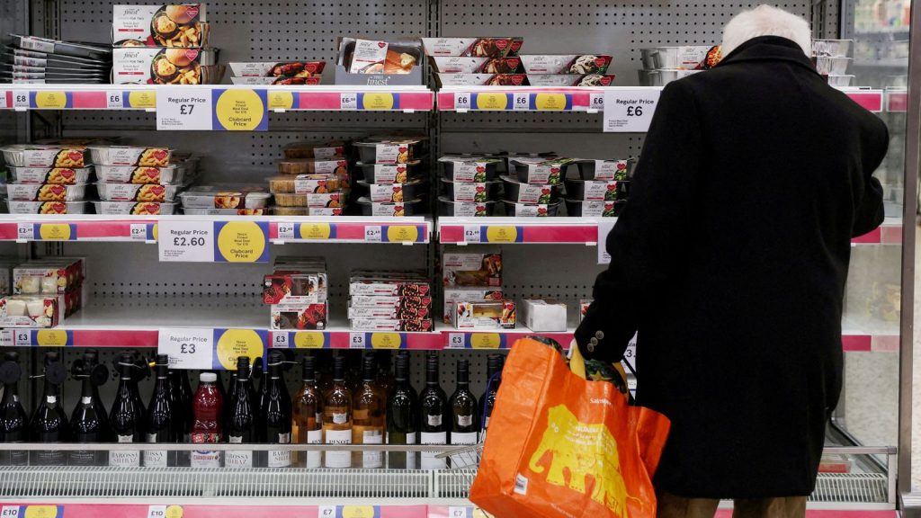 FILE PHOTO: A man shops inside a branch of a Tesco Extra Supermarket in London, Britain, February 10, 2022. Picture taken February 10, 2022. REUTERS/Paul Childs/File Photo